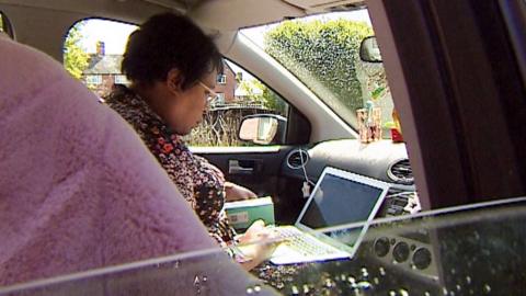 Donna Powell working in a car