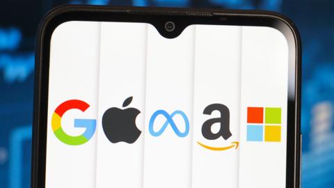 A phone shows the logos of Google, Apple, Meta, Amazon and Microsoft