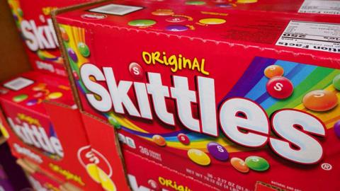 Boxes of Skittles candy are displayed at a Costco Wholesale store on April 27, 2025 in San Diego, California.