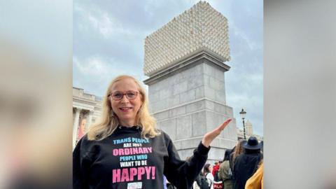 Katie Neeves standing in front of the newly-unveiled sculpture in Traflagar Square