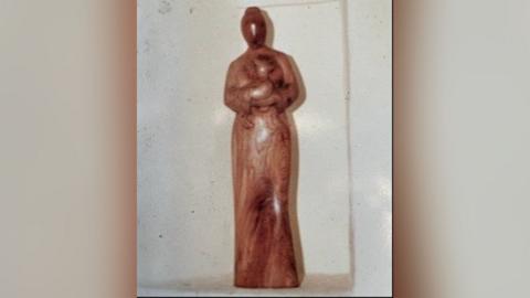Wooden figurine of St Margaret holding a lamb which has been stolen from a church