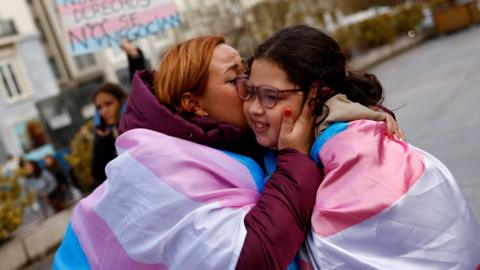 Sonia Izquierdo kisses her daughter Paula as they celebrate the approval of a bill that will make it easier for people to self-identify as transgender