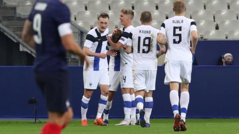 Finland's players celebrate scoring against France in a friendly in Paris