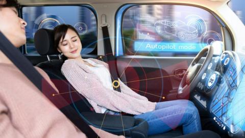 Man and woman asleep in driverless car