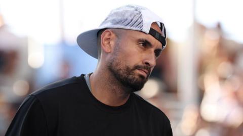 Nick Kyrgios reacts to a point while playing doubles at the Australian Open