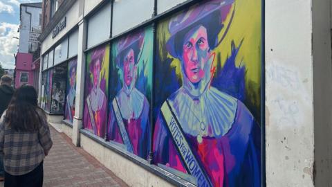 Colourful artwork on the front of a vacant shop lot