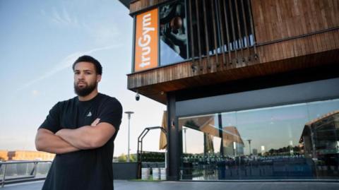 A man with his arms folded, standing outside truGym in Chatham, which will become Club Eight³, a specialist health club for people looking for elite performance and longevity