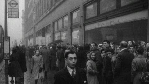 Shoppers line down the street.