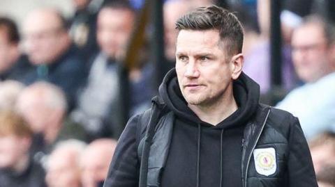 Lee Bell looks on from the touchline during a Crewe match