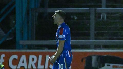 Regan Linney celebrates scoring a goal for Carlisle