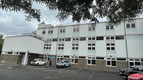 A white three storey school building