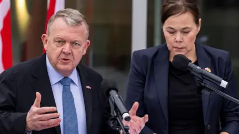 Danish Foreign Minister Lars Lokke Rasmussen (L) and Greenland's Foreign Minister Vivian Motzfeldt
