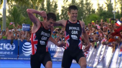 Brothers Alistair and Jonny Brownlee, Alistair on the left his helping carry his brother Jonny on the right over the finish line of a triathlon. Both are in TeamGB kit.