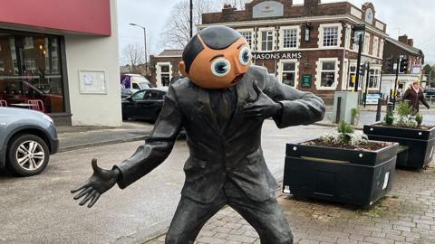 Frank Sidebottom statue on Stockport Street Road in Timperley, Greater Manchester.