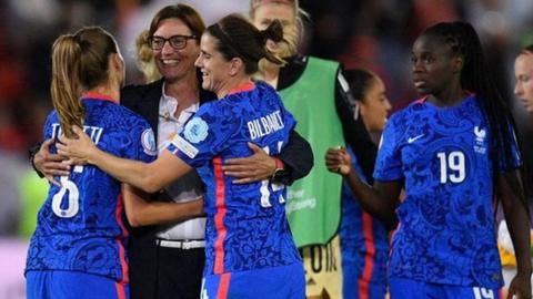 France players celebrate reaching the Euro 2022 knockout stage with their coach Corinne Diacre