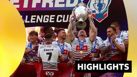 Liam Farrell lifts the Challenge Cup trophy with Wigan Warriors teammates after beating Hull KR in the final.