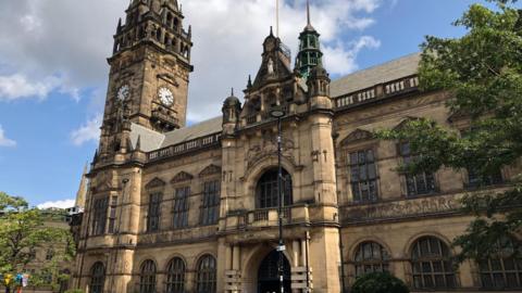A large grand Victoria stone building in the sunshine