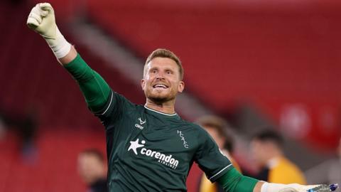 Hull keeper Dillon Phillips celebrates Hull's win over Stoke