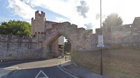 A view of York City Walls, showing a road passing through an archway.