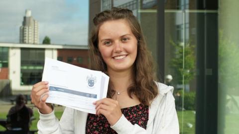 Loughborough College student Katie Simpson holds up her grades