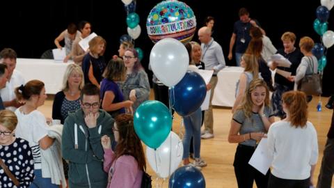 Students react after collecting their A-level exam results at Edgbaston High School for Girls in Birmingham