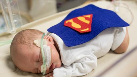 Baby in a Superman costume