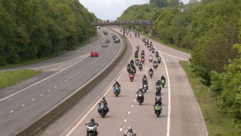 A procession of motorbikes on a motorway