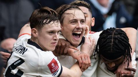 Ben Waine celebrates with Port Vale teammates after scoring against Sunderland