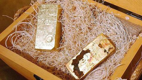 large gold bars inside a wooden case
