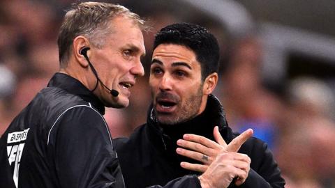 Mikel Arteta, manager of Arsenal, talks to fourth official, Graham Scott during the Premier League match between Newcastle United and Arsenal