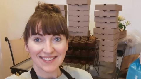 Ros Paterson in front of her boxes of bakes