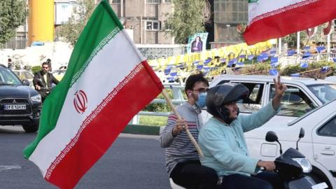 Scooter rally in Tehran with Iranian flags