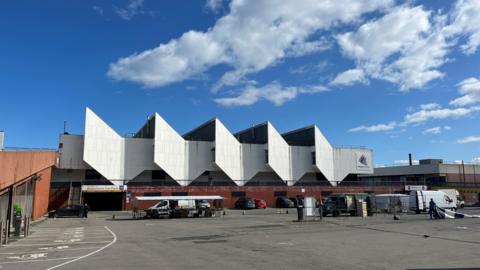 A white building with corrugated edges.