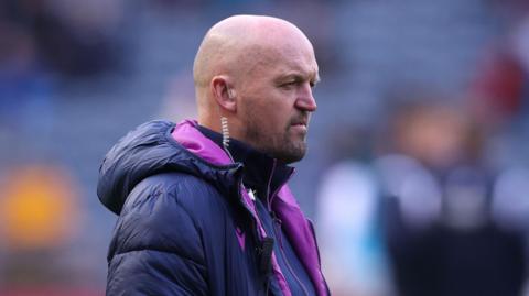 Gregor Townsend, with a speaker in his right ear, watching Scotland train before the Argentina game at Murrayfield 