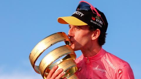 Simon Yates with the Giro d'Italia trophy in 2025