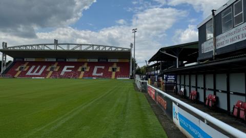 A picture of the pitch and stands at Woking FC's Kingfield Stadium