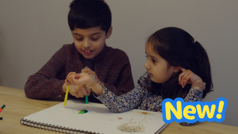 Two siblings share while colouring together.