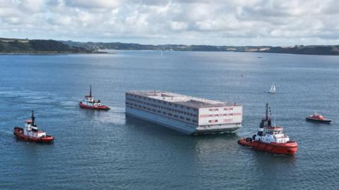 Bibby Stockholm being towed out of Falmouth