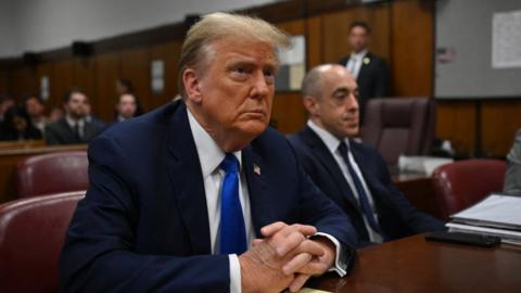 Former US president and Republican presidential candidate Donald Trump looks on at Manhattan Criminal Court during his trial