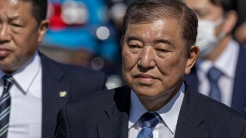 Shigeru Ishiba, Japan's prime minister, leaves after delivering a campaign speech in Osaka. He is wearing a suit. 