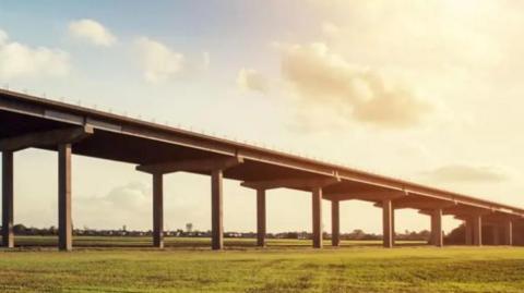 A picture, taken in hazy sunshine, of the M62 Ouse Bridge. Green fields are visible.