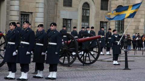 Swedish soldiers take part in the changing of the guard ceremony in the courtyard of the Royal Palace in Stockholm, 25 February 2024