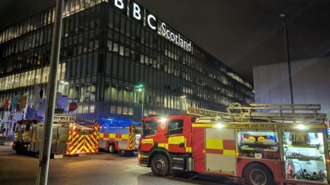 Exterior of BBC Scotland with fire trucks lining the outside entrance