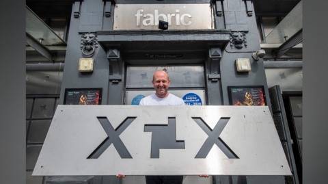 Fabric co-founder Cameron Leslie, holding the sign heading to the London Museum