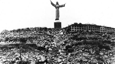 Statue of Christ at Cemetery Hill overlooking Yungay, which together with 4 palm trees, is all that remained of the city.