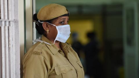 An Indian security guard at the entrance of the swine flu isolation ward in Ahmedabad.