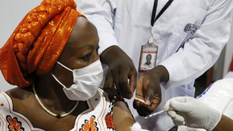 An Ivorian woman receives the first injection of the Covid-19 vaccine, at a vaccination center in Abidjan, Ivory Coast, 01 March 2021.