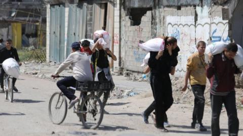 Palestinians with flour sacks