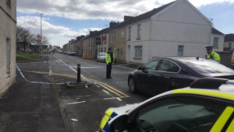 Police officers standing near Seaside square in Llanelli