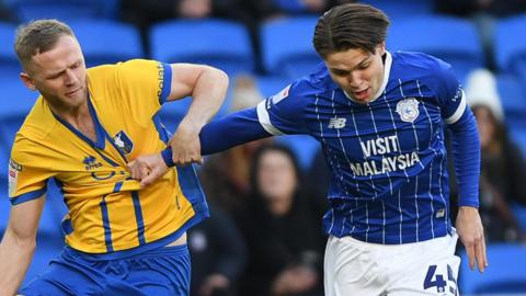 Cian Ashford (R) of Cardiff City is challenged by Frazer Blake-Tracy of Mansfield
